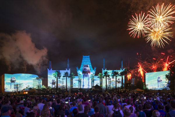 The new nightly Star Wars fireworks show, "Star Wars: A Galactic Spectacular," combines fireworks, pyrotechnics, special effects and video projections that turn the nearby Chinese Theater and other buildings at Disney's Hollywood Studios into the twin suns of Tatooine, a field of battle droids, the trench of the Death Star, Starkiller Base and other Star Wars destinations. The show also features a tower of fire and spotlight beams, creating massive lightsabers in the sky. (David Roark, photographer)