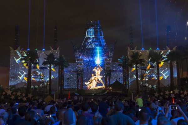 The new nightly Star Wars fireworks show, "Star Wars: A Galactic Spectacular," combines fireworks, pyrotechnics, special effects and video projections that turn the nearby Chinese Theater and other buildings at Disney's Hollywood Studios into the twin suns of Tatooine, a field of battle droids, the trench of the Death Star, Starkiller Base and other Star Wars destinations. The show also features a tower of fire and spotlight beams, creating massive lightsabers in the sky. (David Roark, photographer)